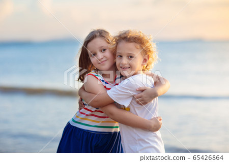 Kids play on tropical beach. Sand and water toy. Kids play on tropical beach. Sand and water toy. 65426864