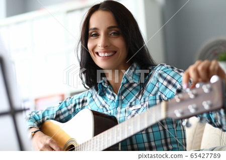 Happy lady with guitar 65427789