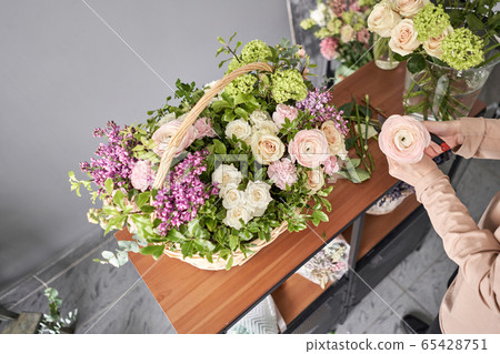 Education in the school of floristry. Master class on making bouquets. Summer bouquet in a wicker basket.. Learning flower arranging, making beautiful bouquets with your own hands. Flowers delivery Education in the school of floristry. Master class on making bouquets. Summer bouquet in a wicker basket.. Learning flower arranging, making beautiful bouquets with your own hands. Flowers delivery 65428751