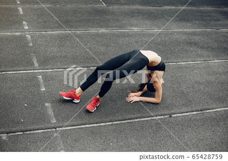 Sports girl training at the stadium 65428759