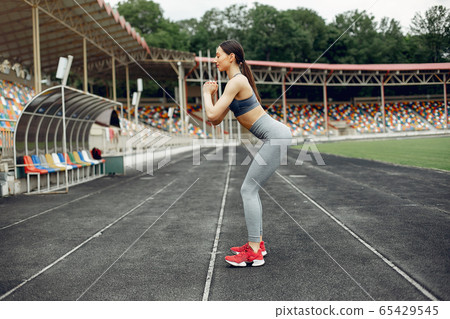 Sports girl training at the stadium 65429545
