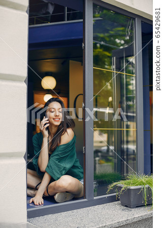 Fashion girl standing in a summer cafe Fashion girl standing in a summer cafe 65429681