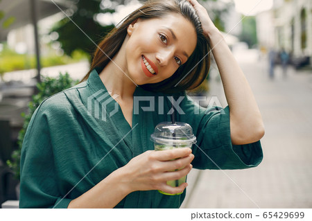Fashion girl standing in a summer city 65429699