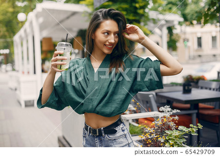 Fashion girl standing in a summer city Fashion girl standing in a summer city 65429709