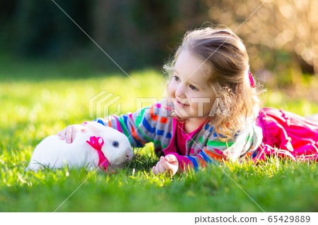 Child with rabbit. Easter bunny. Kids and pets. Child with rabbit. Easter bunny. Kids and pets. 65429889