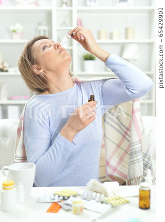 Portrait of ill young woman with tapped nose Portrait of ill young woman with tapped nose 65429901