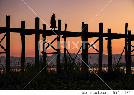 Silhouette of U Bein Bridge at sunrise near Silhouette of U Bein Bridge at sunrise near 65431175