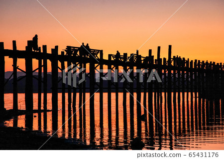 Silhouette of U Bein Bridge at sunrise near Silhouette of U Bein Bridge at sunrise near 65431176