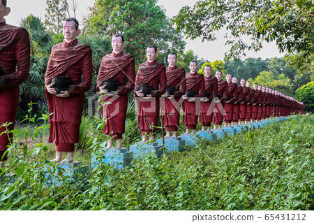 A long row of monk statues at the Kaw Ka Thaung A long row of monk statues at the Kaw Ka Thaung 65431212