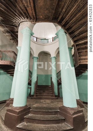 Empty stairwell interior with green columns Empty stairwell interior with green columns 65432833