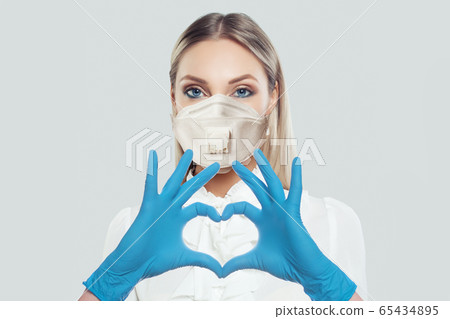 Cute woman in protective mask making heart. Cute woman in protective mask making heart. 65434895