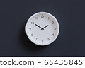 3D Render - White wall clock isolated on dark gray background. Hour hand pointing at 2 and minute hand pointing at 10. 65435845