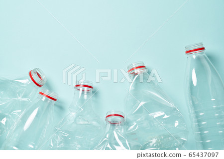 Empty crumpled plastic bottles at blue background 65437097