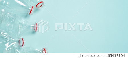 Empty crumpled plastic bottles at blue background Empty crumpled plastic bottles at blue background 65437104