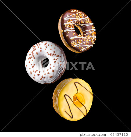 Set of flying glazed donuts with sprinkles on a black background Set of flying glazed donuts with sprinkles on a black background 65437110