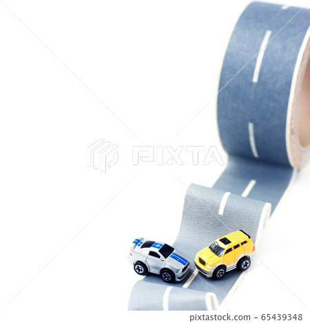 Cars accident on rough road. Two toy models on duct tape. Slippery or rough road. Insurance. Incident 65439348
