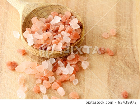 Pink Himalayan Rock Salt in Wooden Spoon. 65439972