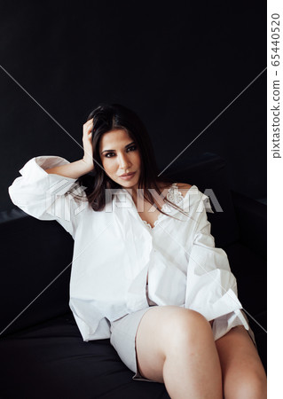 Portrait of a beautiful oriental fashionable brunette woman in shorts and white shirt Portrait of a beautiful oriental fashionable brunette woman in shorts and white shirt 65440520