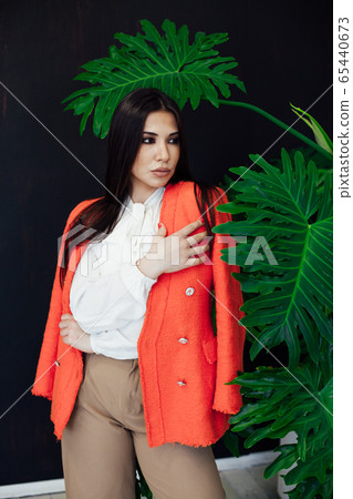 Beautiful fashionable oriental brunette woman in business suit business Beautiful fashionable oriental brunette woman in business suit business 65440673
