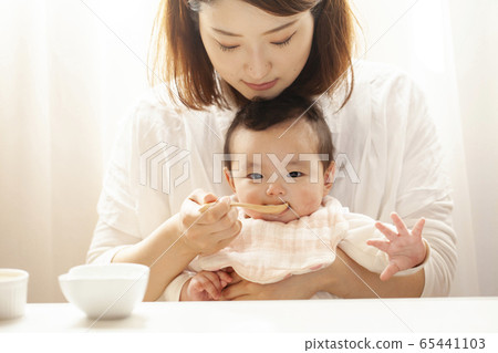Baby eating baby food Baby eating baby food 65441103