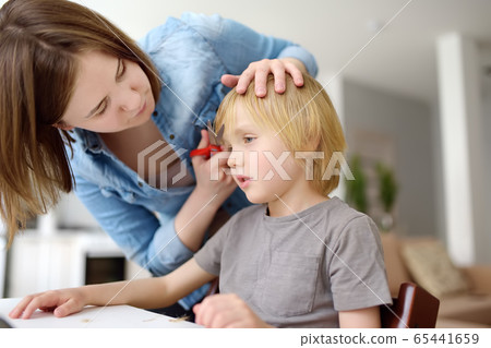 Preschooler boy gets haircut at home during quarantine 65441659