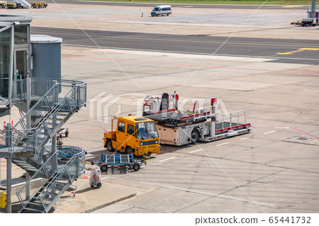 Bridge for boarding passengers with loader near 65441732