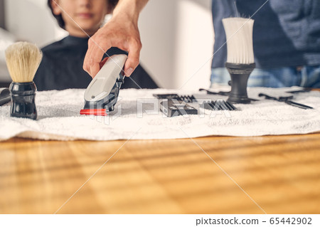 Hairdresser accessories lying on the white surface 65442902