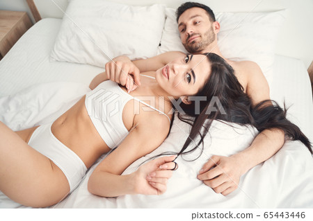 Dreamy Caucasian man holding his wifes hand Dreamy Caucasian man holding his wifes hand 65443446