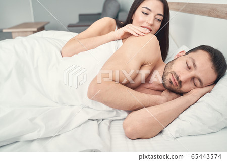 Woman waking up her husband in the morning Woman waking up her husband in the morning 65443574