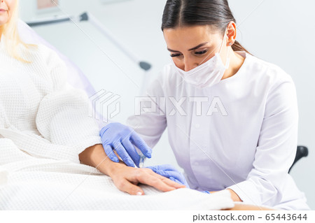 Female patient undergoing a skin rejuvenating treatment Female patient undergoing a skin rejuvenating treatment 65443644