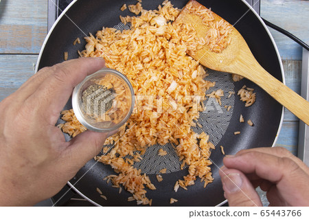 Chef pouring pepper to pan for cook fried rice 65443766