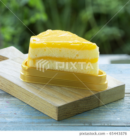 Orange cake on wood plate Orange cake on wood plate 65443876