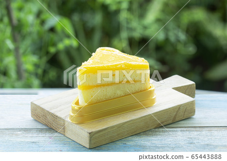 Orange cake on wood plate Orange cake on wood plate 65443888