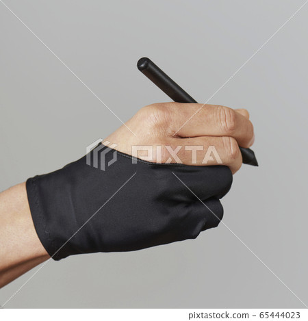 man wearing a two finger glove using a graphic pen 65444023