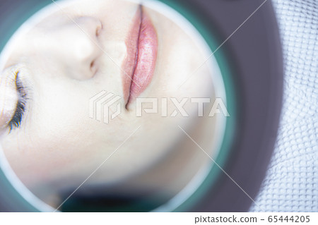 Female patient skin being examined by a doctor 65444205