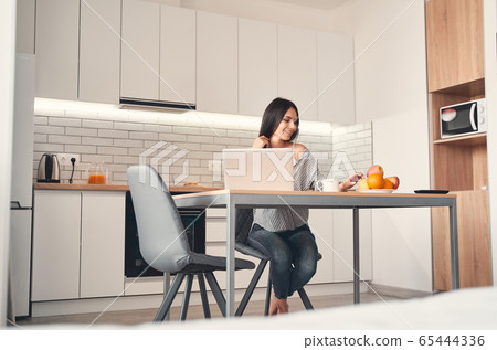 Kind young female looking at yellow apple 65444336