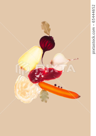 Creative concept of borscht recipe. Sliced vegetables on a brown background with backlight 65444652
