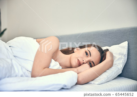Caucasian calm woman having rest in bedroom Caucasian calm woman having rest in bedroom 65445652