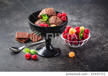 Three brown chocolate ice cream balls Three brown chocolate ice cream balls 65445731
