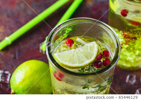 Lime Lemonade with thyme, cranberry and ice. Lime Lemonade with thyme, cranberry and ice. 65446129