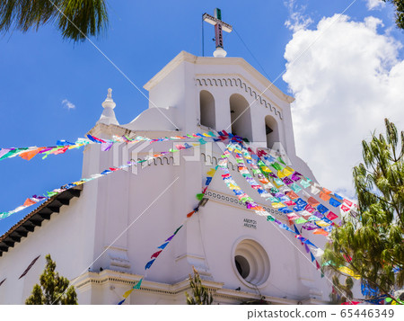Perspective view of San Lorenzo church and its colorful prayer flags , Zinacantan, Chiapas, Mexico 65446349