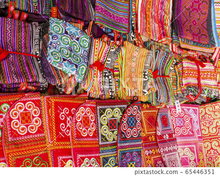 Display of multicolored ethnic fabrics with geometric shapes, Can Cau market, Vietnam 65446351