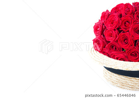 Luxury red roses in straw hat on white. Romantic gift for girl or woman. Copy space Luxury red roses in straw hat on white. Romantic gift for girl or woman. Copy space 65446846