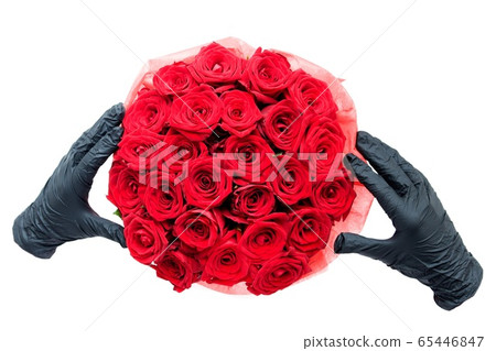 Contactless flower delivery during isolation and coronavirus pandemic. Black medical gloves with red roses in paper box Contactless flower delivery during isolation and coronavirus pandemic. Black medical gloves with red roses in paper box 65446847