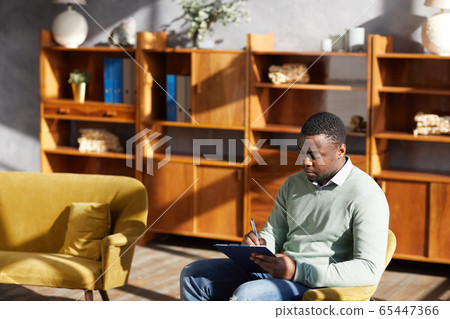 African man making notes 65447366