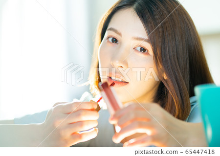 A beautiful woman at home 65447418