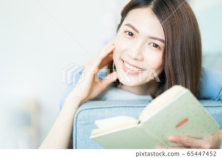 A beautiful woman at home 65447452