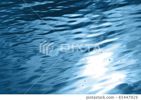 Blue wavy water surface with sun glare Blue wavy water surface with sun glare 65447919