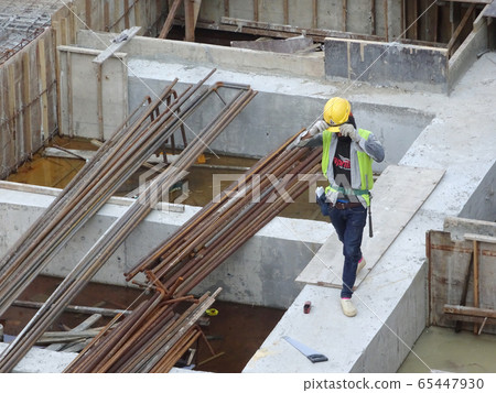 KUALA LUMPUR, MALAYSIA -AUGUST 10, 2017: Construction workers at the construction site doing the daily routine. Wearing appropriate safety gear to avoid an accident. KUALA LUMPUR, MALAYSIA -AUGUST 10, 2017: Construction workers at the construction site doing the daily routine. Wearing appropriate safety gear to avoid an accident. 65447930