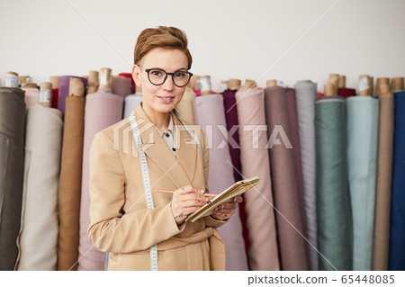 Designer planning her work Designer planning her work 65448085